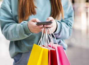 hands-holding-paper-bags-phone-scaled