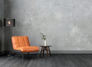 Modern Interior With Orange Colored Leather Armchair, Sconce, Coffee Table And Gray Wall.